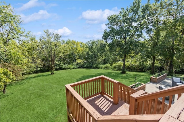 wooden terrace featuring a yard