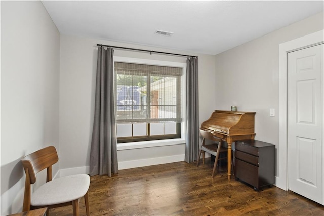 sitting room with dark wood-type flooring