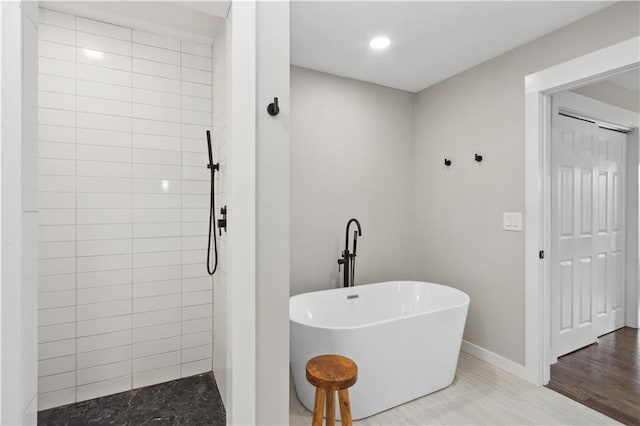 bathroom featuring hardwood / wood-style floors and separate shower and tub