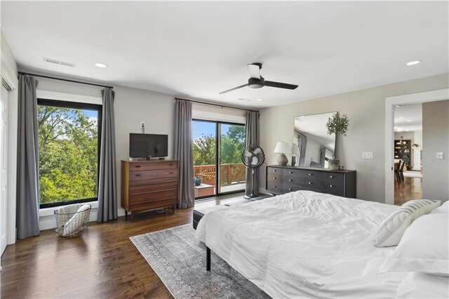 bedroom featuring ceiling fan, access to exterior, dark wood-type flooring, and multiple windows