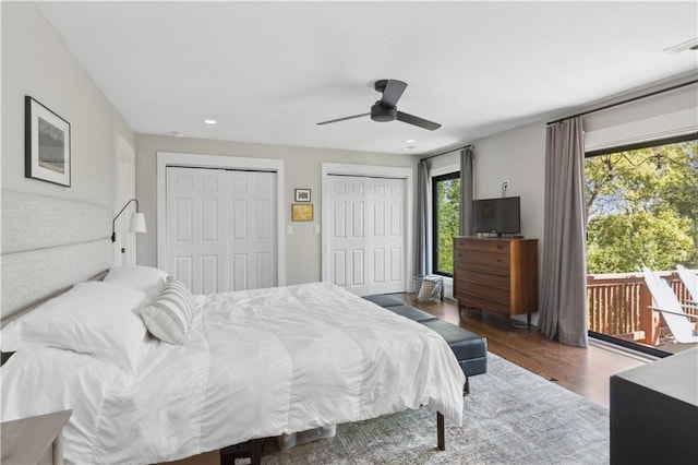 bedroom with multiple windows, ceiling fan, hardwood / wood-style floors, and access to exterior