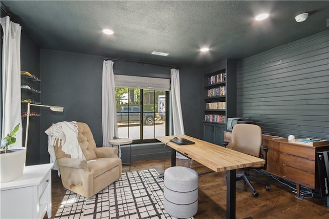 home office with wood-type flooring and a textured ceiling