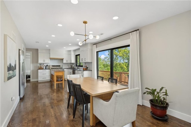 dining space with dark hardwood / wood-style flooring and a notable chandelier