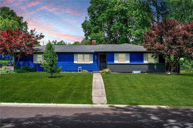 ranch-style house featuring a lawn