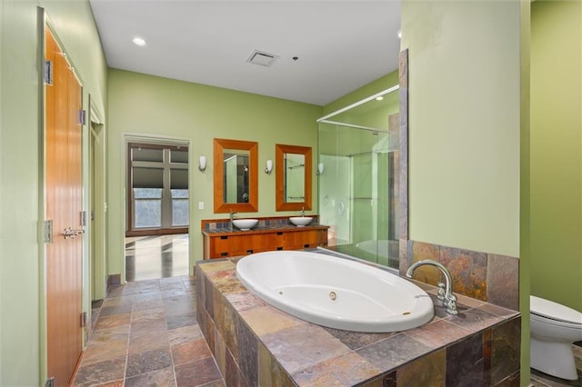 full bathroom featuring vanity, separate shower and tub, and toilet