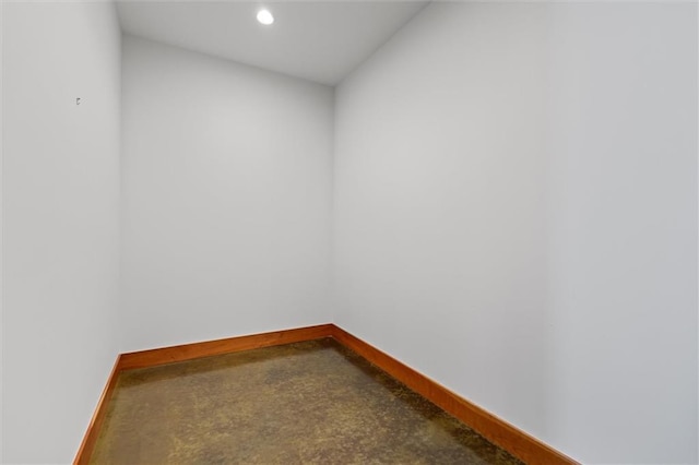 unfurnished room with concrete flooring