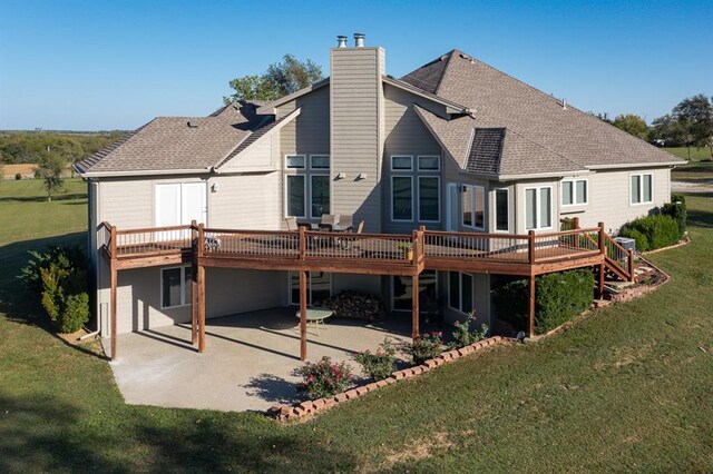 back of house featuring a wooden deck, a patio area, and a yard