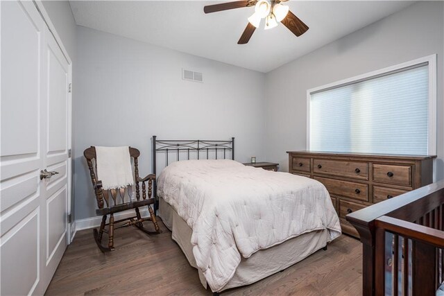 bedroom with ceiling fan, a closet, and dark hardwood / wood-style floors