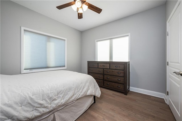 bedroom with ceiling fan and dark hardwood / wood-style floors