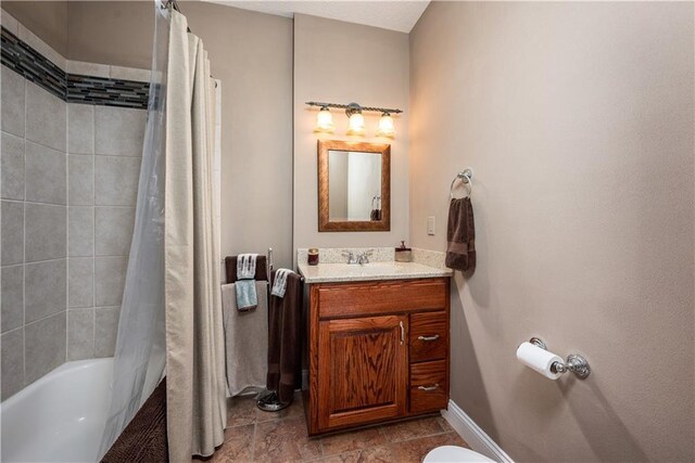 bathroom featuring shower / bath combo and vanity