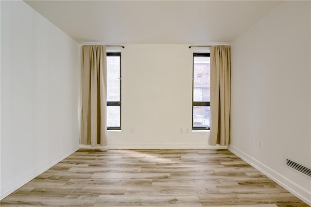 spare room featuring light hardwood / wood-style flooring