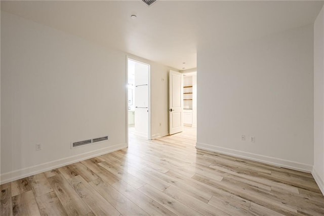 spare room with light wood-type flooring