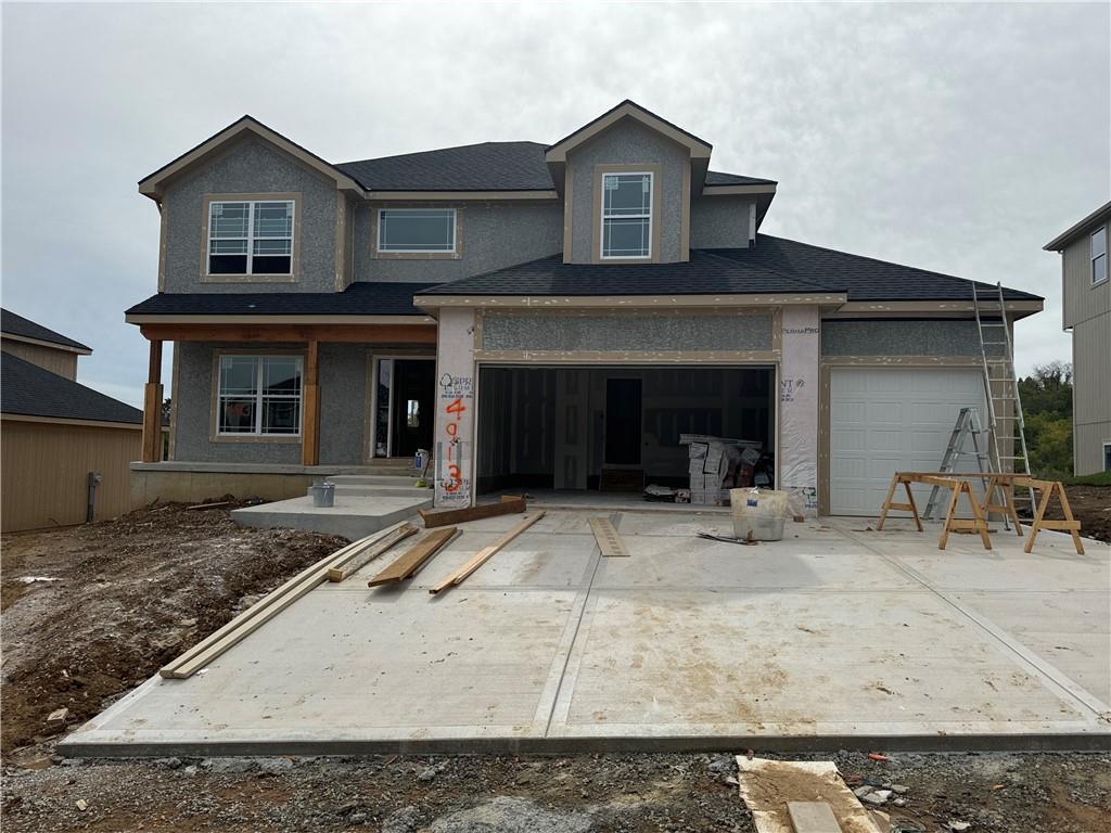 view of front facade featuring concrete driveway and stucco siding