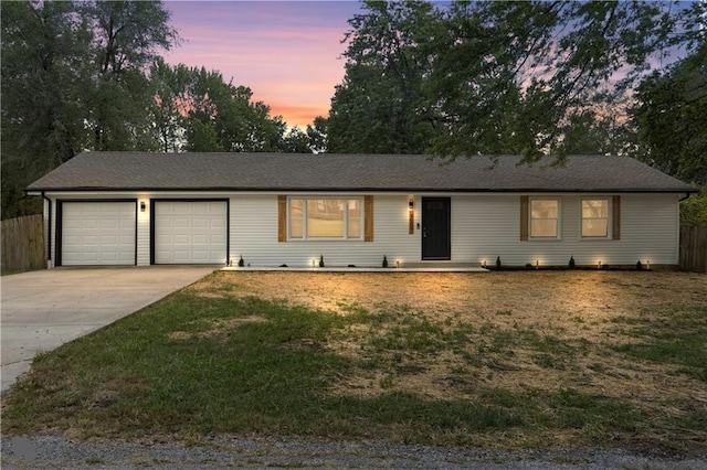 ranch-style house featuring a yard and a garage