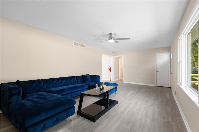 living room featuring ceiling fan and light wood-type flooring