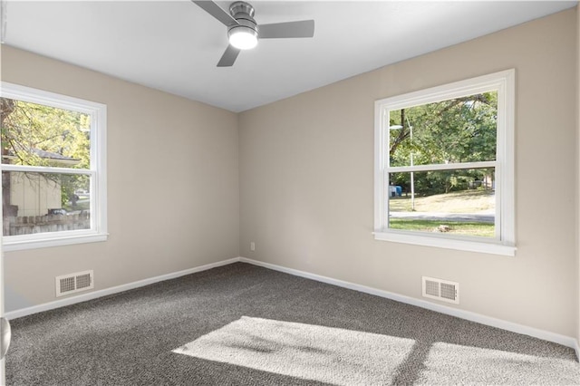 carpeted empty room featuring ceiling fan and a healthy amount of sunlight