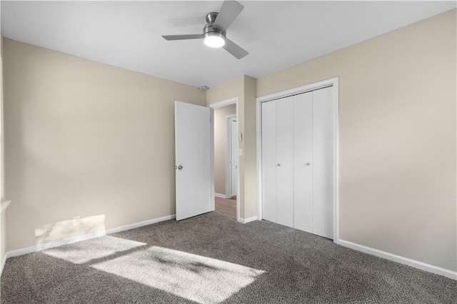 unfurnished bedroom featuring ceiling fan, a closet, and dark colored carpet