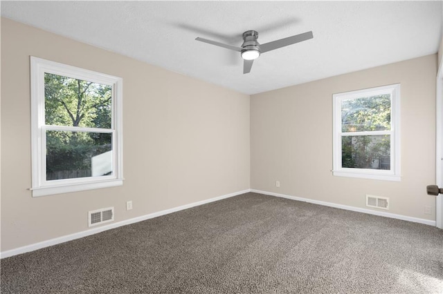 unfurnished room featuring a wealth of natural light, carpet floors, and ceiling fan