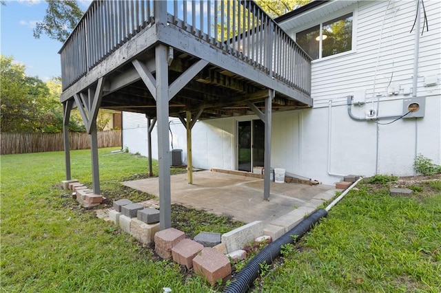 view of patio with cooling unit and a deck