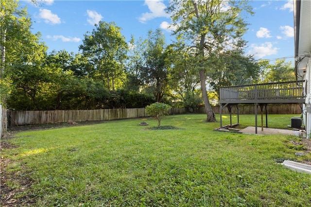 view of yard with a wooden deck and central AC unit