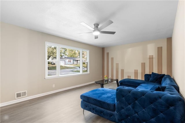 living room with hardwood / wood-style floors and ceiling fan