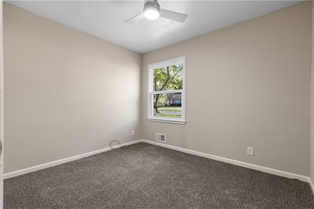 spare room featuring carpet and ceiling fan