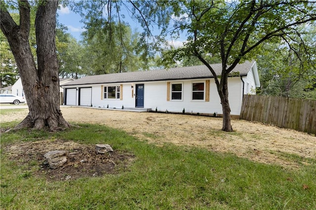 ranch-style home with a garage and a front yard