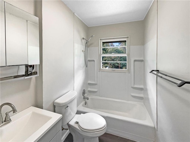 full bathroom with tub / shower combination, vanity, toilet, and wood-type flooring