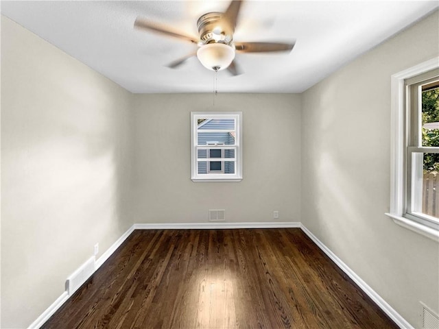 spare room with ceiling fan and dark hardwood / wood-style flooring