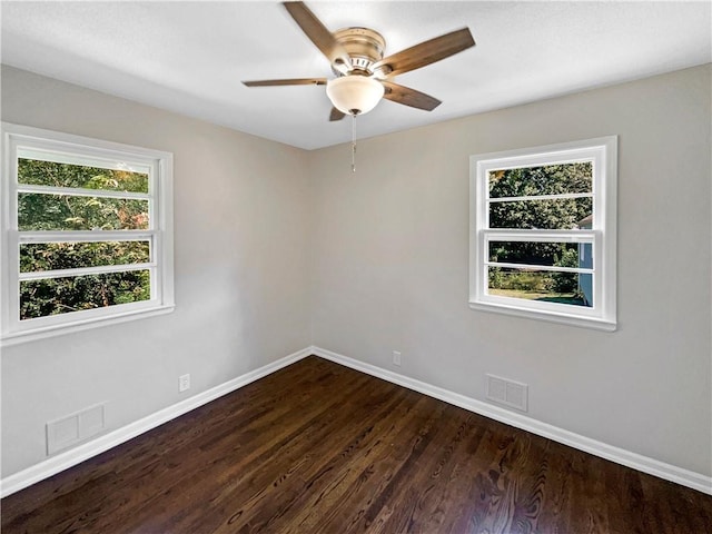 unfurnished room with ceiling fan, dark hardwood / wood-style flooring, and a wealth of natural light