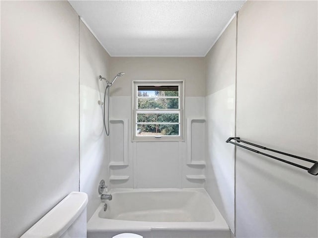 bathroom featuring  shower combination, a textured ceiling, and toilet