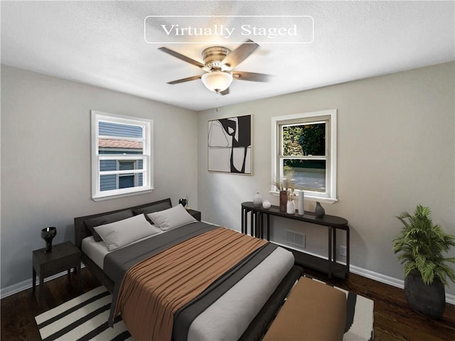 bedroom with ceiling fan and dark wood-type flooring