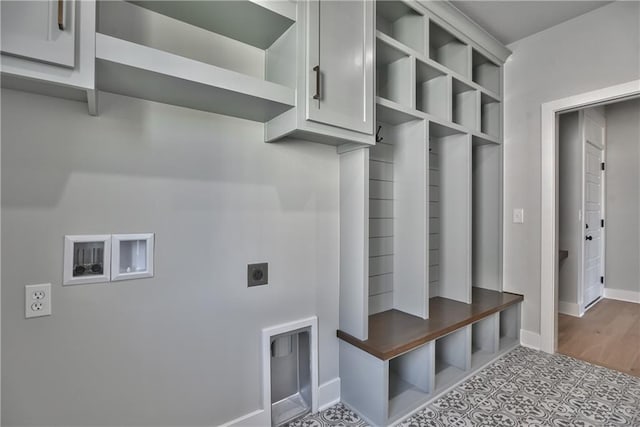 interior space featuring cabinets, hookup for an electric dryer, and hardwood / wood-style floors