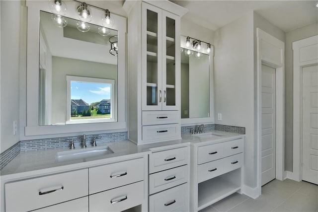 bathroom with vanity, tasteful backsplash, and tile patterned floors