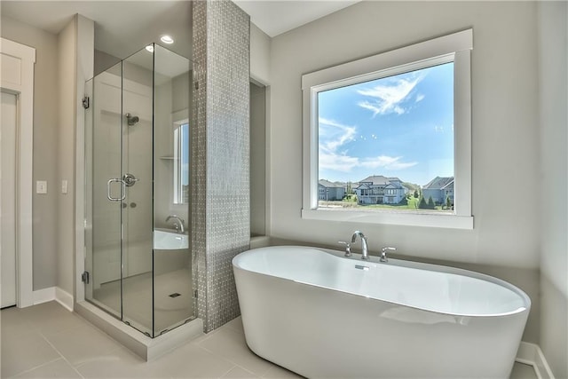 bathroom featuring plus walk in shower and tile patterned floors