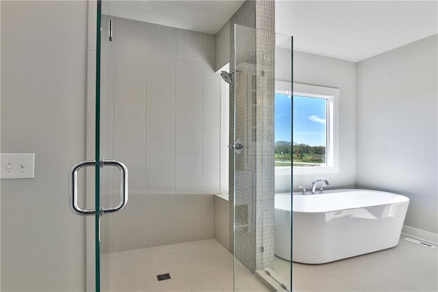 bathroom with tile patterned flooring and separate shower and tub