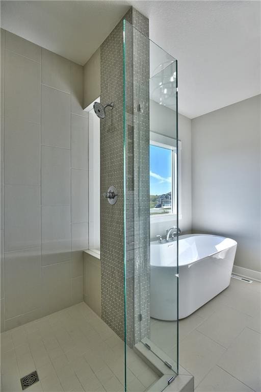 bathroom featuring shower with separate bathtub and tile patterned flooring