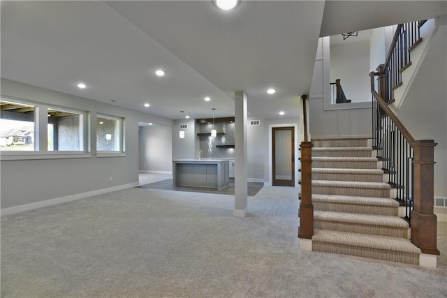 interior space featuring light colored carpet and sink