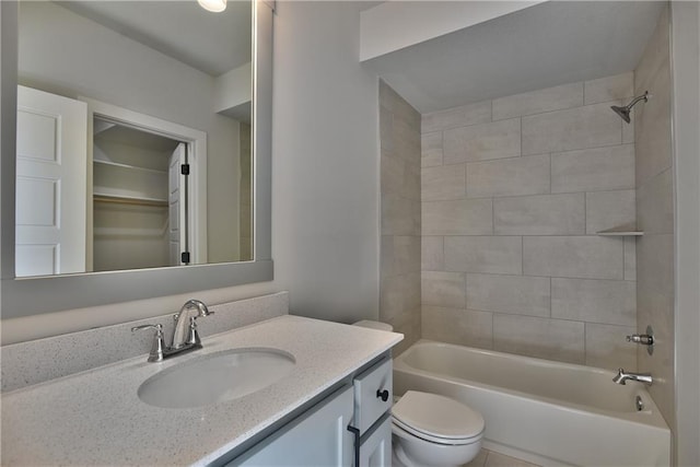 full bathroom featuring vanity, toilet, and tiled shower / bath