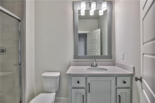 bathroom featuring vanity, toilet, and an enclosed shower