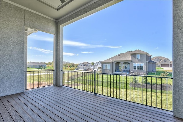 wooden deck featuring a lawn