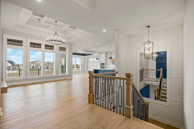 17504 Acton St, Overland Park, KS 66085 - hall with recessed lighting, light wood finished floors, coffered ceiling, an inviting chandelier, and an upstairs landing