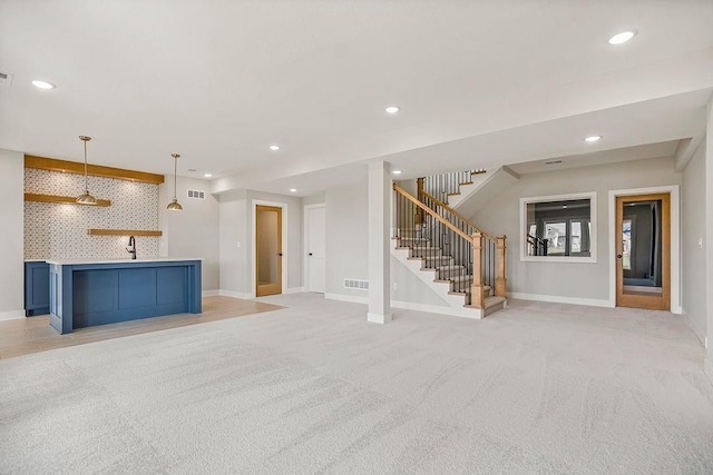 17504 Acton St, Overland Park, KS 66085 - unfurnished living room featuring stairway, baseboards, and light carpet