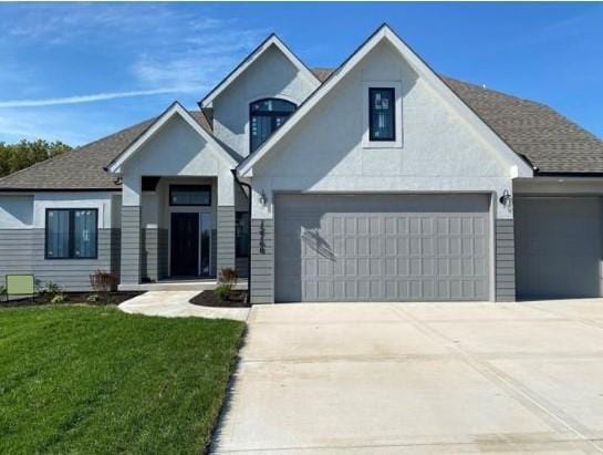 view of front of house featuring a garage and a front lawn