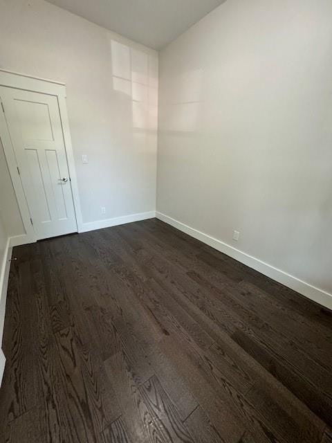 unfurnished room featuring dark hardwood / wood-style floors