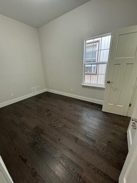 spare room with dark hardwood / wood-style floors