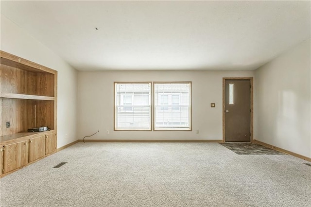 unfurnished living room featuring light carpet