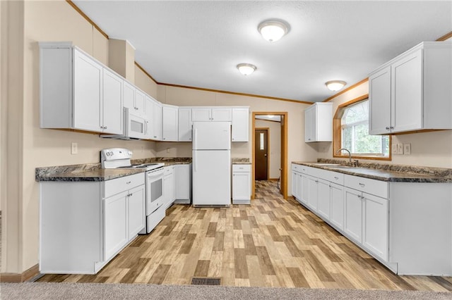 kitchen with light hardwood / wood-style flooring, white appliances, vaulted ceiling, and white cabinetry