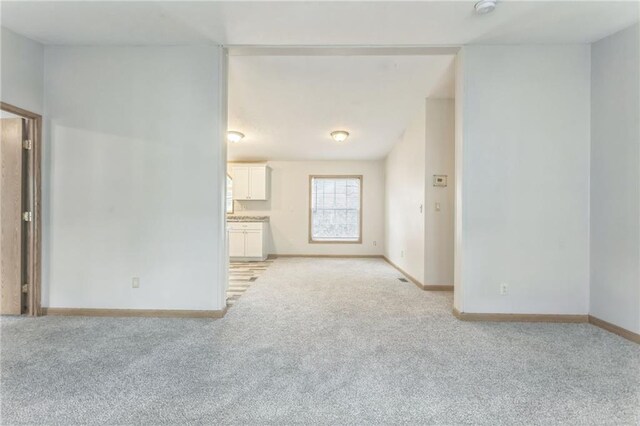 unfurnished living room with light carpet