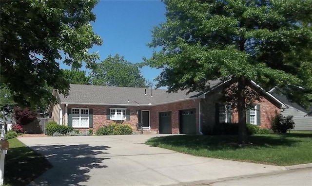 single story home featuring brick siding, driveway, an attached garage, and a front lawn